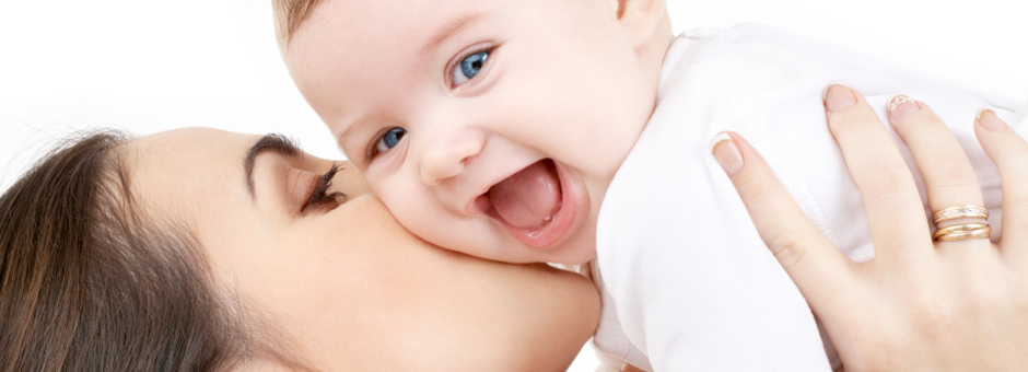 laughing baby playing with mother