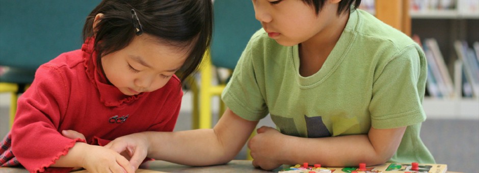 Two children playing with a puzzle